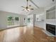 Bright and airy living room featuring large windows, a cozy fireplace, and an open layout leading to the outdoor deck at 1148 Stallings Rd, Matthews, NC 28104