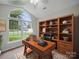 Stylish office space with a large window, built-in shelving, and a comfortable desk for a productive work environment at 1148 Stallings Rd, Matthews, NC 28104