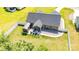 An aerial view of the back of the home highlights the patio, shed, sunroom and fenced yard at 129 Sara Ln, Statesville, NC 28625
