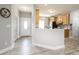 Inviting hallway leading to a bright, modern kitchen with wood-look flooring and neutral paint at 129 Sara Ln, Statesville, NC 28625