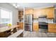 Well-lit kitchen with stainless steel refrigerator, ample wooden cabinets, and stylish countertop at 129 Sara Ln, Statesville, NC 28625
