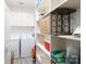 Functional laundry room with washer, dryer, shelving, and storage space at 129 Sara Ln, Statesville, NC 28625