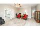 Cozy living room with ceiling fan, red accent chairs and access to a bedroom through french doors at 129 Sara Ln, Statesville, NC 28625