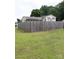 The backyard features a spacious lawn and a tall wooden privacy fence for outdoor living at 145 Honeycutt Rd, Salisbury, NC 28144