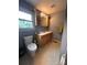 Bathroom with a single sink vanity, decorative mirror with lighting, and a window at 145 Honeycutt Rd, Salisbury, NC 28144