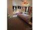 Bright bedroom featuring a cozy bed, shelves, a desk, and pink chairs at 145 Honeycutt Rd, Salisbury, NC 28144