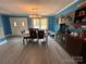 A formal dining area with a long dining table, hutch, and natural light from the large windows at 145 Honeycutt Rd, Salisbury, NC 28144