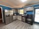 Bright kitchen with stainless steel refrigerator, a window over the sink, and light gray cabinets at 145 Honeycutt Rd, Salisbury, NC 28144
