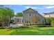 The back exterior features a well-maintained lawn, beautiful landscaping, and a charming patio area at 16909 Red Cow Rd, Charlotte, NC 28277