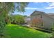 A lush backyard with mature trees, manicured lawn, and well-designed patio area at 16909 Red Cow Rd, Charlotte, NC 28277