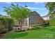 Picture of a cozy backyard area with lush greenery, brick patio, and colorful landscaping at 16909 Red Cow Rd, Charlotte, NC 28277