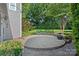 A circular brick patio set in a lush green backyard, perfect for outdoor entertaining at 16909 Red Cow Rd, Charlotte, NC 28277