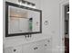 Bright bathroom with a marble vanity top, dark hardware, and a framed mirror at 16909 Red Cow Rd, Charlotte, NC 28277