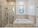 The bathroom features a shower, a bathtub, and tile flooring at 16909 Red Cow Rd, Charlotte, NC 28277