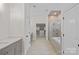 Hallway to main bath features dual vanities, a walk-in closet and separate tub and shower at 16909 Red Cow Rd, Charlotte, NC 28277
