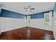 Elegant bedroom features hardwood floors, wainscoting and natural light from the windows at 16909 Red Cow Rd, Charlotte, NC 28277