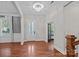 Elegant foyer featuring hardwood floors, a modern chandelier, and abundant natural light at 16909 Red Cow Rd, Charlotte, NC 28277