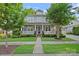 Charming two-story home with a welcoming front porch, manicured lawn, and mature trees at 16909 Red Cow Rd, Charlotte, NC 28277