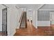 Spacious hallway with hardwood floors, elegant trim, and a staircase leading to the upper level at 16909 Red Cow Rd, Charlotte, NC 28277
