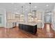 Spacious kitchen with a large center island, stainless steel appliances, and decorative pendant lighting at 16909 Red Cow Rd, Charlotte, NC 28277