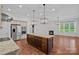 Modern kitchen with stainless appliances, large island, and adjacent living area with a cozy fireplace at 16909 Red Cow Rd, Charlotte, NC 28277