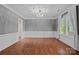 Elegant living room featuring hardwood floors, a large window, and sophisticated trim work throughout at 16909 Red Cow Rd, Charlotte, NC 28277