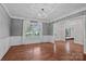 Elegant living room featuring hardwood floors, a large window, and sophisticated trim work throughout at 16909 Red Cow Rd, Charlotte, NC 28277