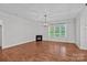 Spacious living room features hardwood floors, fireplace, large windows and modern lighting at 16909 Red Cow Rd, Charlotte, NC 28277