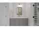 Stylish powder room showcasing a sleek vanity with stone countertop, decorative mirror, and ample storage at 16909 Red Cow Rd, Charlotte, NC 28277