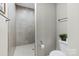 Bathroom features a walk-in tiled shower and toilet with a towel bar at 1712 Askern Ct, Waxhaw, NC 28173