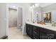 Bathroom with double vanity, tiled shower and walk in closet at 1712 Askern Ct, Waxhaw, NC 28173