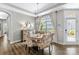 Dining area with modern chandelier, lots of light, and decorative sideboard at 1712 Askern Ct, Waxhaw, NC 28173