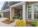 Inviting front porch with stone accents, comfortable seating, and attractive landscaping at 1712 Askern Ct, Waxhaw, NC 28173