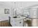Bright kitchen featuring an island with a sink, pendant lighting, and an adjacent dining area for a modern and inviting space at 1712 Askern Ct, Waxhaw, NC 28173