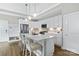 Contemporary kitchen with white cabinets, stainless steel appliances, and breakfast bar at 1712 Askern Ct, Waxhaw, NC 28173
