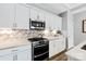 Bright kitchen with stainless steel appliances, tile backsplash, and white cabinets at 1712 Askern Ct, Waxhaw, NC 28173