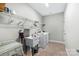 Functional laundry room with modern appliances, storage shelves, and a utility sink for added convenience at 1712 Askern Ct, Waxhaw, NC 28173