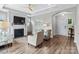 Spacious living room with fireplace, ceiling fan, and arched entry, creating a welcoming atmosphere at 1712 Askern Ct, Waxhaw, NC 28173