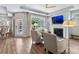 Bright living room with fireplace, ceiling fan, and large windows offering natural light and backyard views at 1712 Askern Ct, Waxhaw, NC 28173