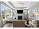 Inviting living room with fireplace, tray ceiling, and many windows at 1712 Askern Ct, Waxhaw, NC 28173