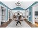 Open lounge area with a fireplace and meeting tables with chairs and a blue and white color scheme at 1712 Askern Ct, Waxhaw, NC 28173