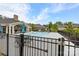 Community pool with a black metal safety fence and lounge chairs with umbrellas surrounding the pool deck at 1712 Askern Ct, Waxhaw, NC 28173