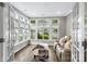 Bright sunroom features large windows, natural light, and cozy seating for relaxation at 1712 Askern Ct, Waxhaw, NC 28173