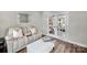 Cozy sunroom with a plush recliner, white ottoman, and views of the outdoors at 1712 Askern Ct, Waxhaw, NC 28173