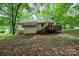 Exterior view of backyard with deck, siding and a wooded lot at 1802 Deer St, Charlotte, NC 28214