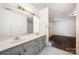 Bathroom with double sink vanity and a glimpse into an adjacent bedroom at 1802 Deer St, Charlotte, NC 28214