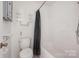 Standard bathroom featuring a toilet, shower/tub combo, and minimal storage at 1802 Deer St, Charlotte, NC 28214