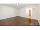 Bedroom with hardwood floors, white walls, and a bathroom en suite at 1802 Deer St, Charlotte, NC 28214