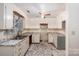 This kitchen features gray marble countertops and flooring, white cabinets and a ceiling fan at 1802 Deer St, Charlotte, NC 28214