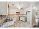 This kitchen features white cabinets, gray marble countertops and flooring, and a ceiling fan at 1802 Deer St, Charlotte, NC 28214